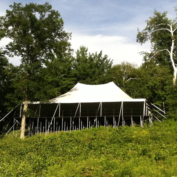 standard pole tent installed on staging and flooring