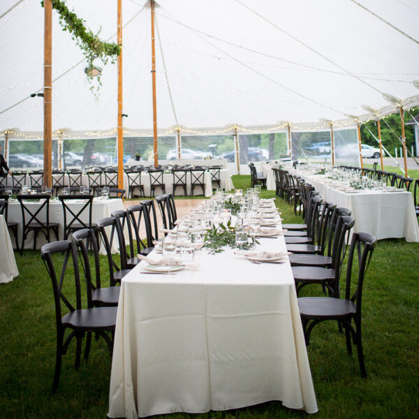 black crossback chair under a sailcloth tent with dance floor