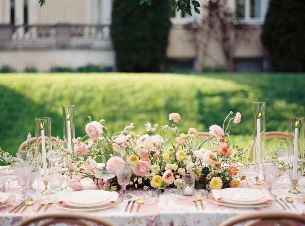 Easter dinner and jewish passover table inspiration with accents of pink colors and floral patterns.